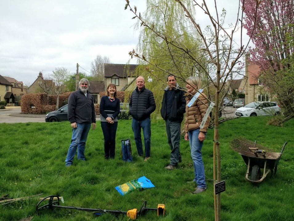 Volunteers planting a cherry tree by Fettiplace